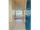 Bright tiled foyer leading into a carpeted living space with a sliding glass door to a lanai at 3629 Indigo Pond Dr # 3629, Palm Harbor, FL 34685