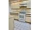 Kitchen featuring white appliances and cabinetry, and white tile floors at 3629 Indigo Pond Dr # 3629, Palm Harbor, FL 34685