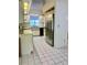 Eat-in kitchen area featuring stainless steel refrigerator, and white tile flooring at 3629 Indigo Pond Dr # 3629, Palm Harbor, FL 34685