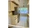 Bright kitchen featuring a window, tiled floor, and cabinetry at 3629 Indigo Pond Dr # 3629, Palm Harbor, FL 34685