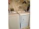 Laundry room equipped with a white front-load washer and dryer set for convenient laundry at 3629 Indigo Pond Dr # 3629, Palm Harbor, FL 34685