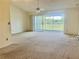 Spacious living room with sliding glass doors leading to a balcony at 3629 Indigo Pond Dr # 3629, Palm Harbor, FL 34685