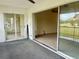 Bright living room with an access to the carpeted patio overlooking the community golf course at 3629 Indigo Pond Dr # 3629, Palm Harbor, FL 34685