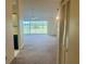 Open-concept living room with neutral carpet, ceiling fan, and sliding glass doors to the outside at 3629 Indigo Pond Dr # 3629, Palm Harbor, FL 34685