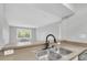 Kitchen sink with stainless steel basin, faucet, and view to living area at 406 W Cedar St # 403, Tampa, FL 33606