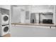 Galley kitchen with stacked washer/dryer and stainless steel appliances at 406 W Cedar St # 403, Tampa, FL 33606