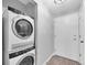 Laundry closet with an Electrolux stacked washer and dryer, and a door to the side at 406 W Cedar St # 403, Tampa, FL 33606