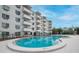 An outdoor community pool is surrounded by a patio and apartment building at 406 W Cedar St # 403, Tampa, FL 33606