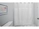 Neutral bathroom with a framed print and white shower curtain at 4105 W Corona St, Tampa, FL 33629