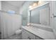 Well-lit bathroom featuring a white vanity with marble countertop and a shower with white tile surround at 4105 W Corona St, Tampa, FL 33629