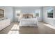 Sunlit bedroom boasts plush carpet, white furnishings, and large windows at 4105 W Corona St, Tampa, FL 33629