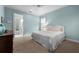 Comfortable bedroom with light blue walls, white trim, and ensuite bathroom access, creating a relaxing retreat at 4105 W Corona St, Tampa, FL 33629