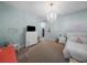Cozy bedroom with a modern chandelier, dresser, and closet, offering both style and functionality at 4105 W Corona St, Tampa, FL 33629