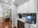 Butler pantry with beverage center, wine cooler, and white cabinetry, enhancing entertainment possibilities at 4105 W Corona St, Tampa, FL 33629