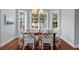 Sun-filled dining area with hardwood floors and windows overlooking the backyard at 4105 W Corona St, Tampa, FL 33629