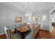 Elegant dining room with a large table, striped chairs, hardwood floors, and a stunning chandelier at 4105 W Corona St, Tampa, FL 33629