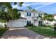 Charming two-story home featuring a two-car garage, a balcony, and a well-maintained brick driveway at 4105 W Corona St, Tampa, FL 33629