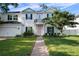 Charming two-story home with manicured lawn, brick pathway, and a welcoming pink front door at 4105 W Corona St, Tampa, FL 33629