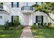 Close up of the charming two-story home, manicured lawn and welcoming pink front door at 4105 W Corona St, Tampa, FL 33629
