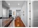 Upstairs hallway with hardwood floors and white trim, illuminated by recessed lighting at 4105 W Corona St, Tampa, FL 33629