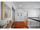 Upstairs hallway with hardwood floors, white railings, and neutral paint, creating a welcoming transition space at 4105 W Corona St, Tampa, FL 33629