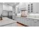 Modern kitchen with white cabinets, marble countertops, stainless steel appliances, and a gas cooktop at 4105 W Corona St, Tampa, FL 33629