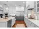 Well-appointed kitchen with stainless steel appliances, white cabinetry, a center island, and hardwood floors at 4105 W Corona St, Tampa, FL 33629