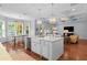 Bright, open kitchen features a center island, farmhouse sink, pendant lighting, hardwood floors, and stainless steel appliances at 4105 W Corona St, Tampa, FL 33629