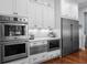Eat-in kitchen features stainless steel appliances, white cabinets, a microwave, and a built-in oven at 4105 W Corona St, Tampa, FL 33629