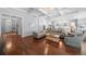 Open-concept living area showcasing hardwood floors, coffered ceilings, and access to a modern kitchen at 4105 W Corona St, Tampa, FL 33629