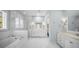 This primary bathroom includes dual vanities, a walk-in shower, and a free-standing tub at 4105 W Corona St, Tampa, FL 33629