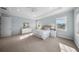 This main bedroom features natural light, tray ceilings, carpet floors, an ensuite bathroom, and a walk-in closet at 4105 W Corona St, Tampa, FL 33629