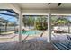 View of the screened-in patio area showcasing the columns, brick flooring, and pool at 4105 W Corona St, Tampa, FL 33629