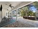 View of the screened-in patio area showcasing the dining table, brick flooring, and pool at 4105 W Corona St, Tampa, FL 33629