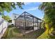 Screened pool enclosure and outdoor lounge area overlooking the yard, creating an ideal space for entertainment at 4105 W Corona St, Tampa, FL 33629