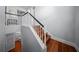 Wooden staircase with white banister and black handrail leading to the second floor at 4105 W Corona St, Tampa, FL 33629