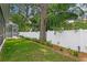 Backyard with lush green lawn and white vinyl fence offering privacy and charm at 4310 W Sevilla St, Tampa, FL 33629