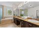 Bathroom with a soaking tub, dual sinks, granite countertops and vanity area at 4310 W Sevilla St, Tampa, FL 33629