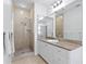 Bathroom with tile shower, granite countertops, and updated sink and fixtures at 4310 W Sevilla St, Tampa, FL 33629