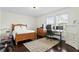 Bedroom featuring a wooden bed, a desk setup for work, and warm natural light at 4310 W Sevilla St, Tampa, FL 33629
