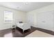 Cozy bedroom featuring a white bed frame, dark wood floors, and natural light at 4310 W Sevilla St, Tampa, FL 33629