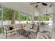 Relaxing covered patio offers ample seating, ceiling fans, and views of the backyard at 4310 W Sevilla St, Tampa, FL 33629