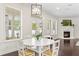 Bright dining area with a white table, many windows, dark wood floors and a fireplace in the same space at 4310 W Sevilla St, Tampa, FL 33629