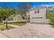 Elegant two-story home with a paver driveway, manicured lawn, and a two-car garage at 4310 W Sevilla St, Tampa, FL 33629