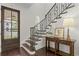 Elegant foyer with dark wood floors, decorative iron staircase, and console table at 4310 W Sevilla St, Tampa, FL 33629