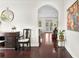 Inviting hallway with dark wood floors, an arched doorway, and decorative furnishings at 4310 W Sevilla St, Tampa, FL 33629