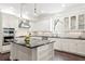 Modern kitchen featuring white cabinets, black countertops, and stainless steel appliances at 4310 W Sevilla St, Tampa, FL 33629