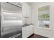 Kitchen area showcasing stainless steel appliances, white cabinets, and a view of the porch at 4310 W Sevilla St, Tampa, FL 33629