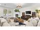 Cozy living room with fireplace, large windows, comfortable seating, and wood floors at 4310 W Sevilla St, Tampa, FL 33629