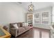 Cozy living room features a comfortable couch, bookshelf, a modern ceiling light fixture and windows at 4310 W Sevilla St, Tampa, FL 33629